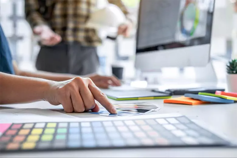 A designer choosing elements for their visual communication project.