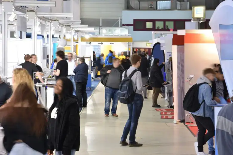 People exploring different exhibition stalls People exploring different exhibition stalls