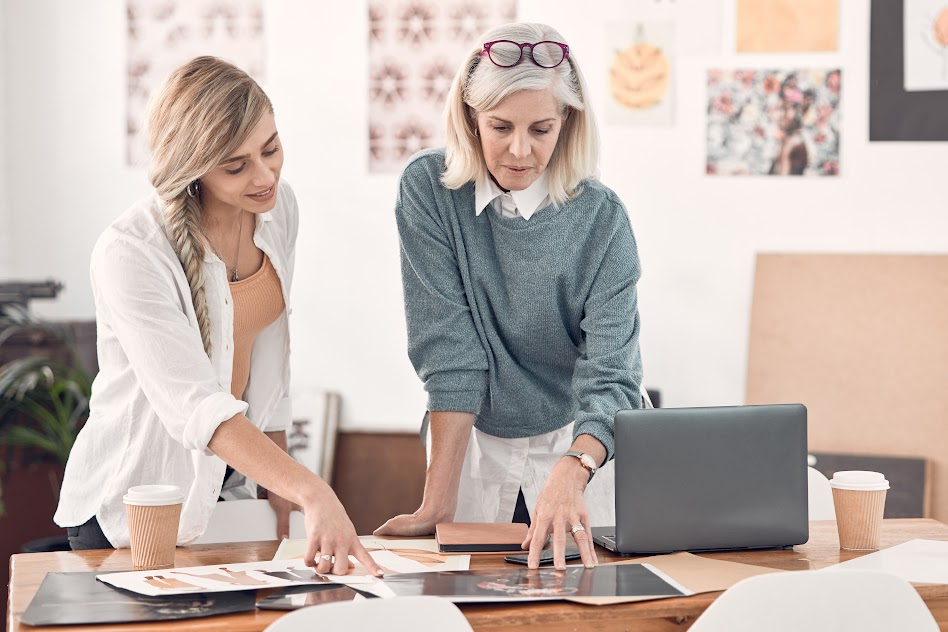 Fashion designer discussing store layout planning with visual merchandiser. Fashion designer discussing store layout planning with visual merchandiser.