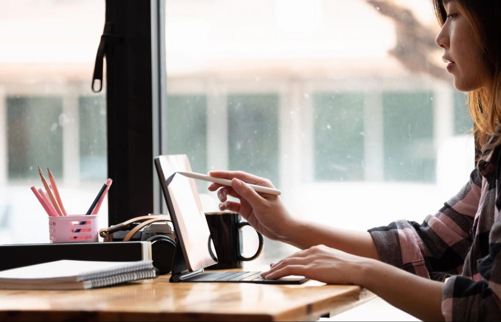 Picture of a motion graphic designer using a tablet for a design project.

