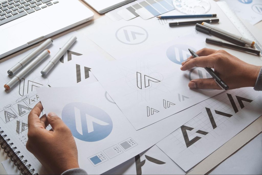 A person sketches a logo design on paper, focusing on branding design concepts.
A person sketches a logo design on paper, focusing on branding design concepts.