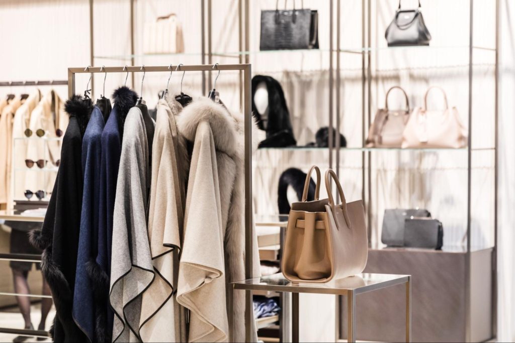 A modern store displays dresses styled by a visual merchandiser
