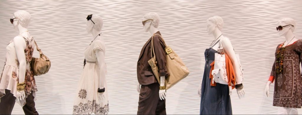 Picture of a store displays mannequins styled by a visual merchandiser