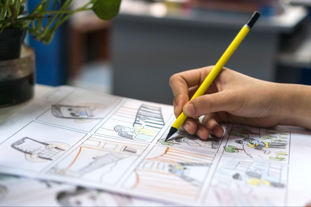 Picture of a motion graphic designer using a pencil to create a drawing on paper
