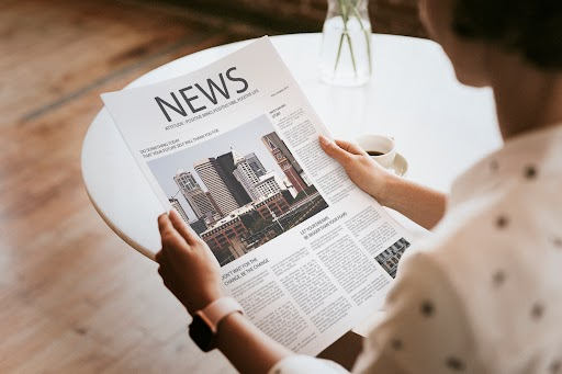 Image showcasing woman reading a piece on interior design, focusing on Indian Royal Aesthetic.