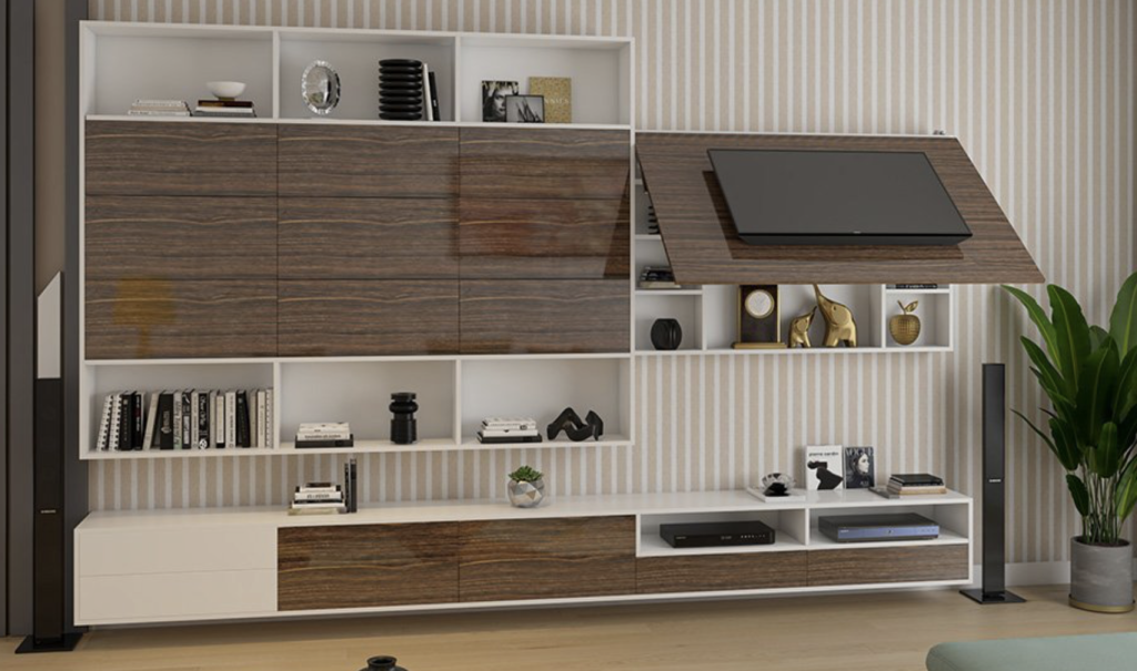 An entertainment center with built-in shelving and a TV mount. An entertainment center with built-in shelving and a TV mount.