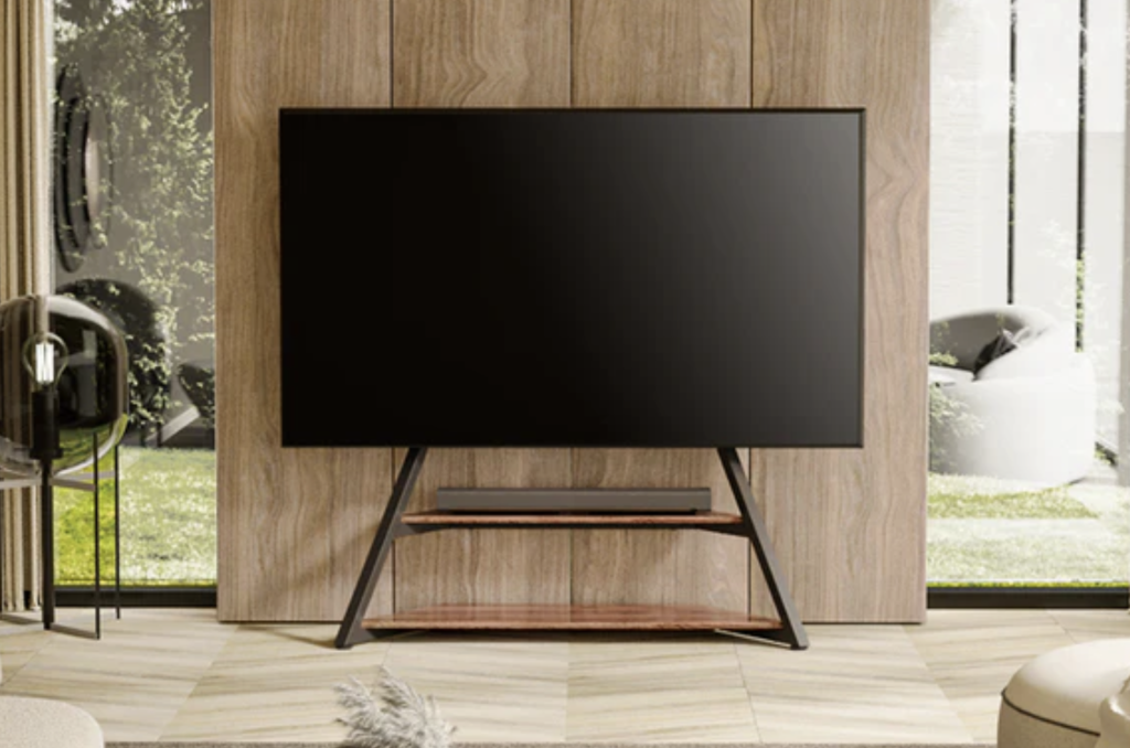 A modern TV on a minimalist stand against a wood panel wall. A modern TV on a minimalist stand against a wood panel wall.