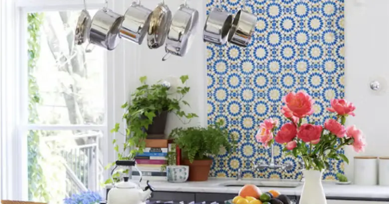 A kitchen with a blue and white patterned tile backsplash