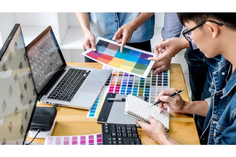 Young professional comparing RGB and CMYK color systems for web design.
Young professional comparing RGB and CMYK color systems for web design.
