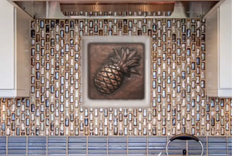 Kitchen with a decorative tile backsplash and a pineapple accent.