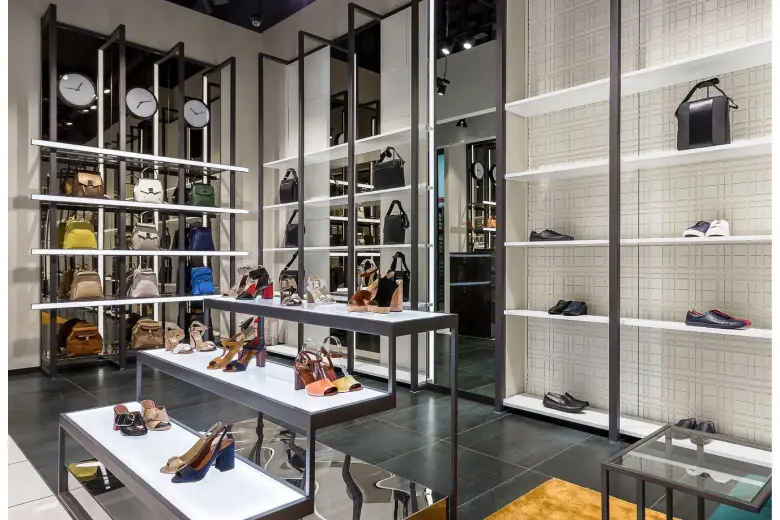 Picture of a modern shop interior design featuring shoes, bags, and minimalist shelving.
