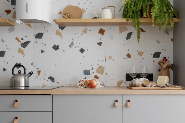 Kitchen with terrazzo tile backsplash.