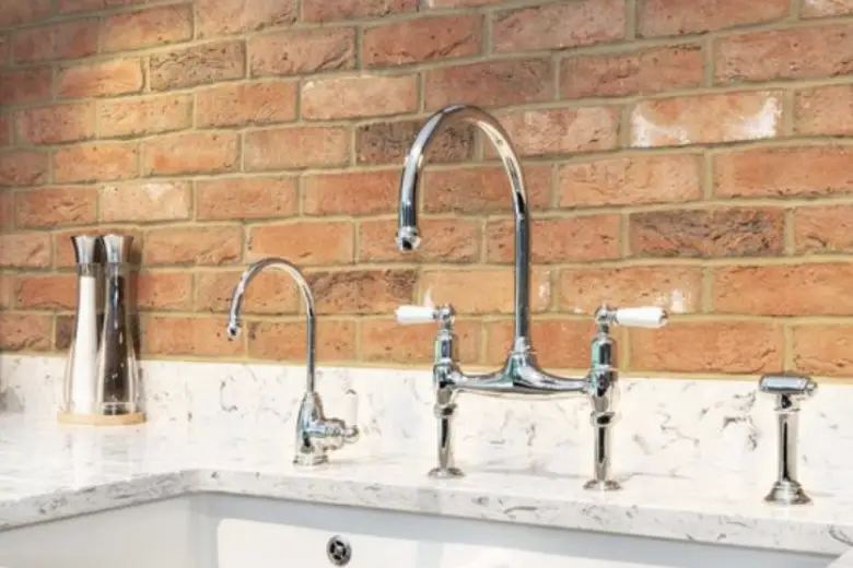 Kitchen with red brick-style tile backsplash.
