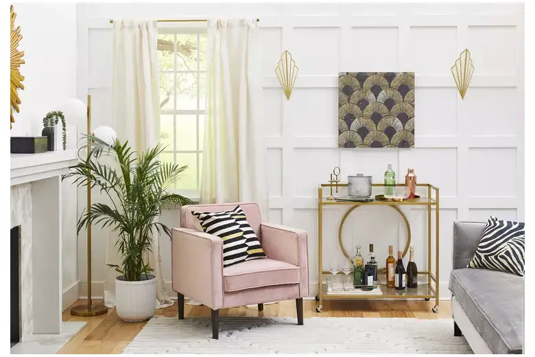 Art deco style living room with pink chair and gold accents. Art deco style living room with pink chair and gold accents.