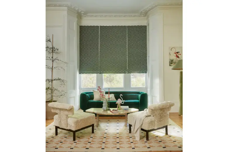 Living room with art deco geometric blinds and green sofa.
Living room with art deco geometric blinds and green sofa.