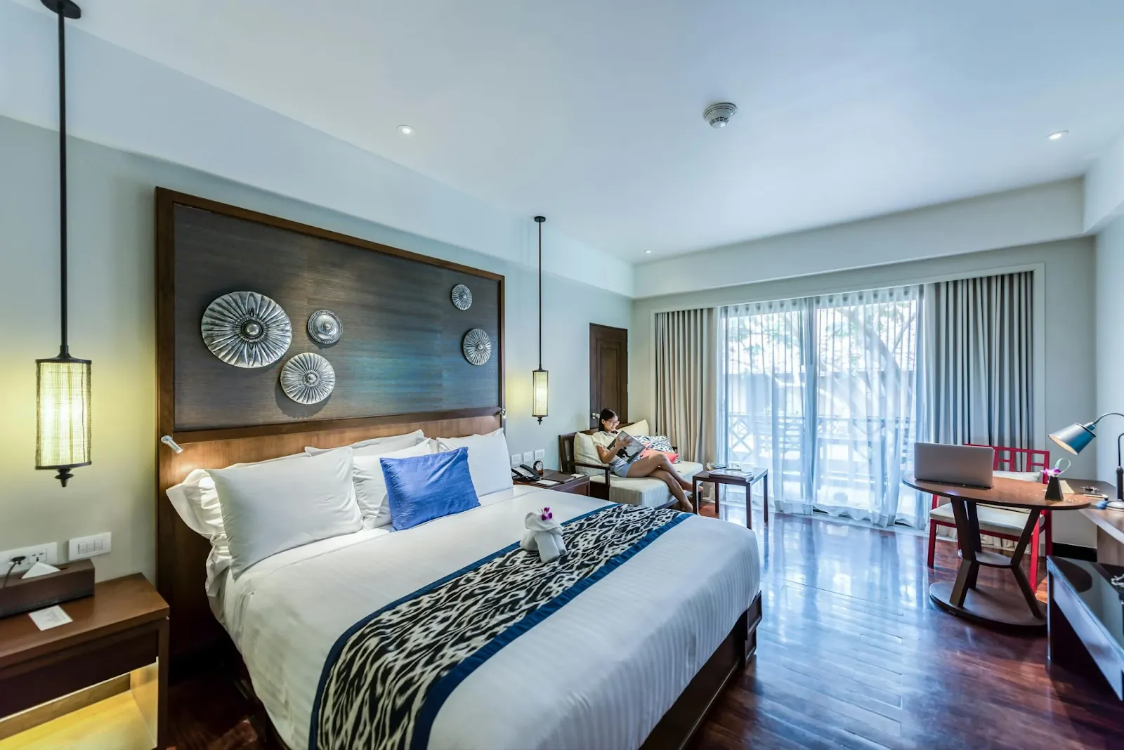 Bedroom design with insulated windows and blackout curtains for a dark, quiet sleep environment.