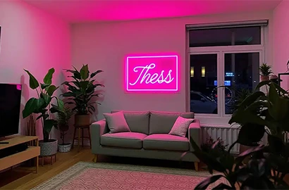 Pink custom neon sign in a home lounge, adding a vibrant and cozy look.
