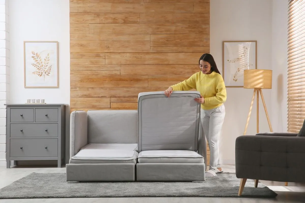 A woman integrating smart home furniture in her living room