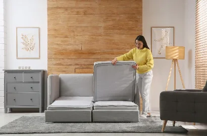 A woman integrating smart home furniture in her living room