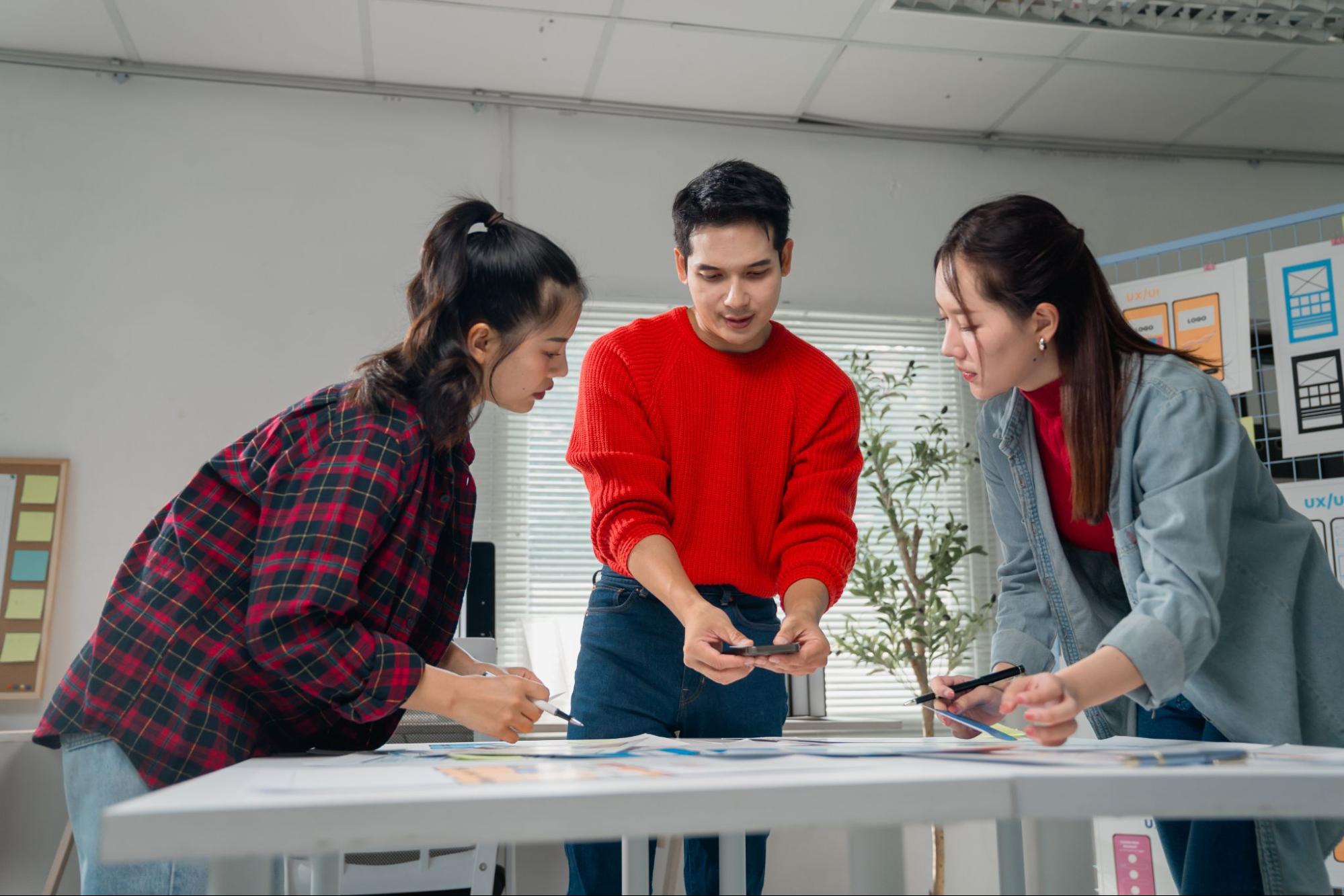 Design professionals discussing application of UI UX design trends